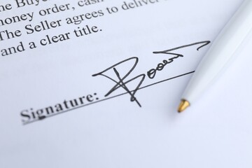 Ballpoint pen and signature on contract, closeup