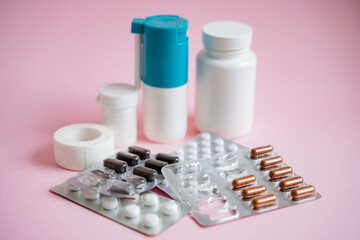 A vibrant and colorful assortment of various pills and bottles is artistically arranged against a...