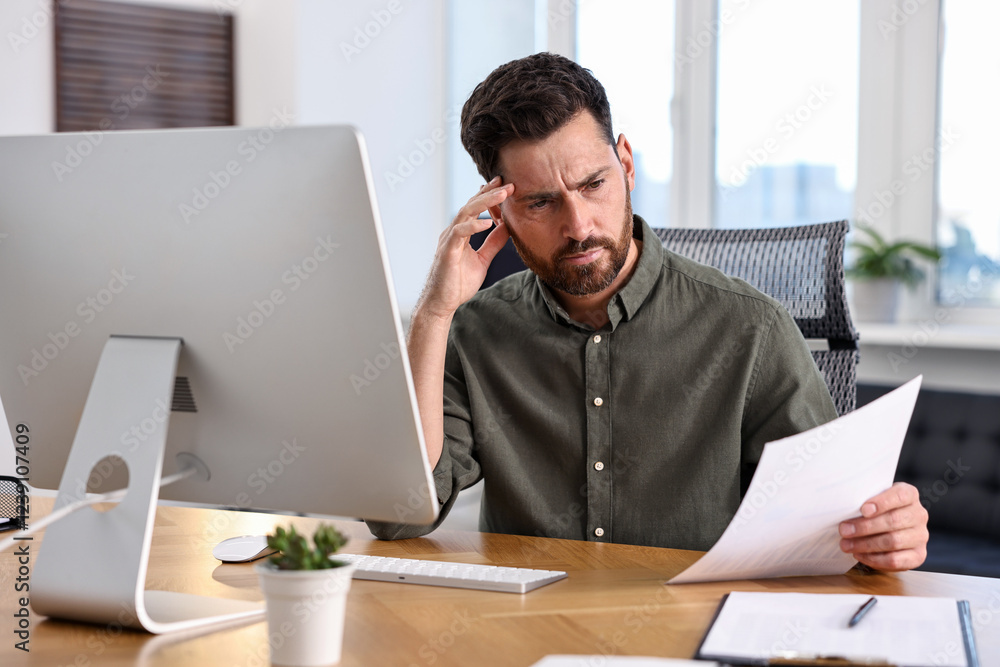Poster man with document working at table in office