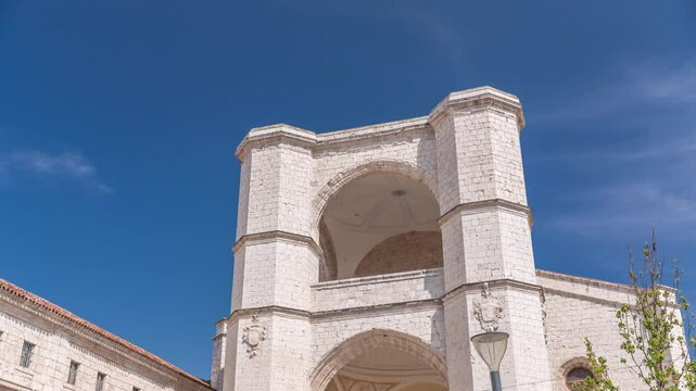 Church of San Benito el Real timelapse, a historic Benedictine monastery in Valladolid, Spain. The Gothic-style facade stands tall under a blue sky, capturing the essence of medieval architecture.