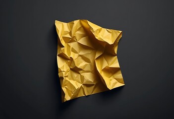 A crumpled yellow paper sheet on dark background