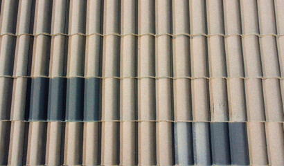 Grey roof tiles arranged in a regular pattern, creating a textured and uniform surface