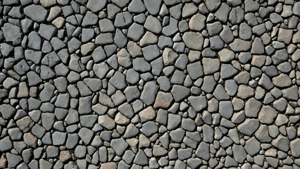 Seamless texture of grey cobblestones, ideal for background or design element.  High-resolution image showcasing irregular stone shapes and natural variations.