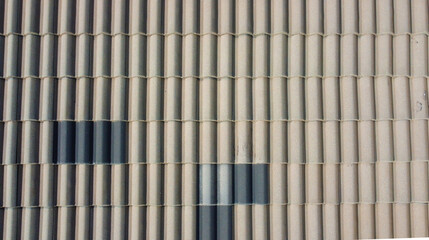 Grey roof tiles arranged in a regular pattern, creating a textured and uniform surface