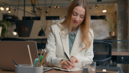 Caucasian serious businesswoman student girl female manager employer office worker business woman work video call conference distant chat class lesson e-learning laptop computer talking writing notes