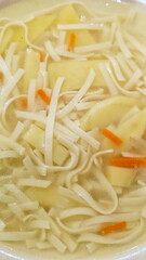 Noodles in chicken broth with herbs