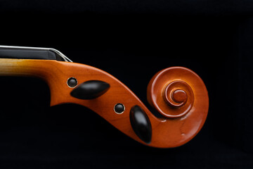 A detailed macro shot highlighting the delicate strings and fine craftsmanship of a violin. Ideal for educational materials, music lessons, or artistic backgrounds.