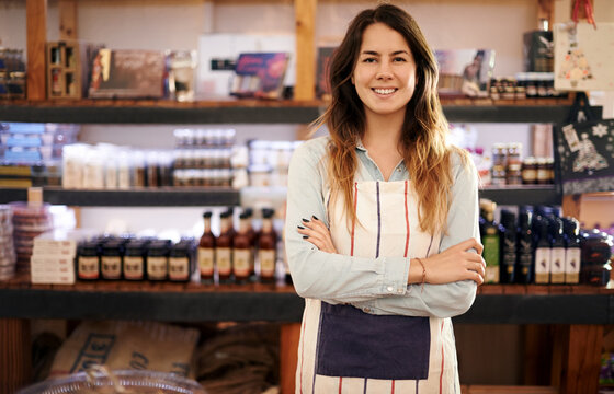 Portrait, happy woman and coffee shop owner in small business for welcome, hospitality or service industry. Barista, cafe or confident entrepreneur in startup franchise with arms crossed at pub in UK