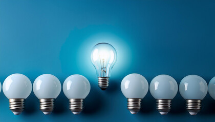 one sparkling mild bulb stands proud among unlit white bulbs on a blue historical past