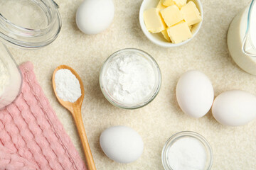 Baking powder and other ingredients for making dough on table, flat lay