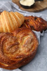 Different delicious pastries on grey table, closeup