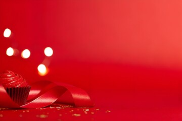 A warm, blurred orange background with glowing bokeh lights and subtle golden particles