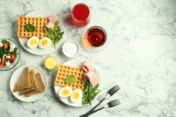 Flat lay composition with tasty brunch served on white marble table. Space for text
