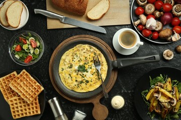 Tasty food served for brunch on black table, flat lay