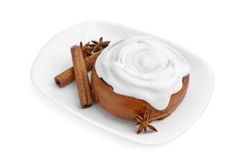 Tasty cinnamon roll with cream and spices isolated on white