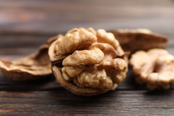 Fresh walnuts on wooden table, closeup view