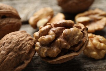 Fresh walnuts with shells on table, closeup