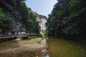 chongqing.china 24.03.2024 Tourists walking along a scenic nature trail at the breathtaking Three Natural Bridges in Wulong Karst National Geopark, Wulong City, China.