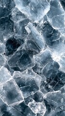 Fototapeta premium Glittering shards of ice create a stunning visual as they lie scattered on a textured dark surface. The various sizes and angles reflect light, evoking a sense of cool freshness and crystal clarity