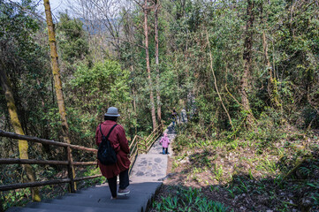 chongqing.china 24.03.2024 Tourists walking along a scenic nature trail at the breathtaking Three Natural Bridges in Wulong Karst National Geopark, Wulong City, China.