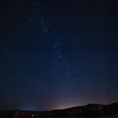 Fototapeta premium Starry night sky over forest landscape