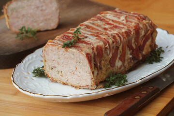 Bacon wrapped Meatloaf on the white plate