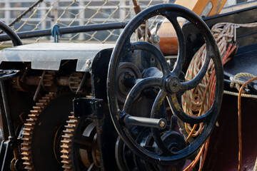 Close-up of a Ship's Winch with Metal Gears and Steering Wheel