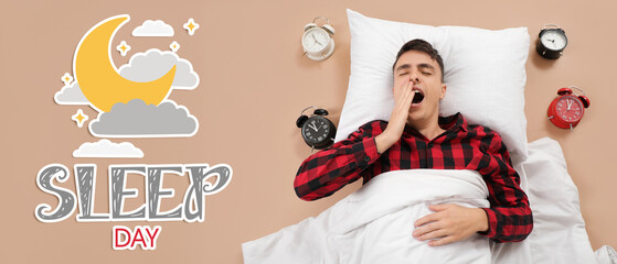 Young man with alarm clocks yawning on beige background