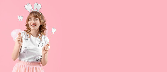 Tooth Fairy with paper teeth on pink background