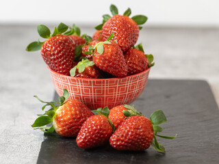 closeup of bowl of strawberries on slate