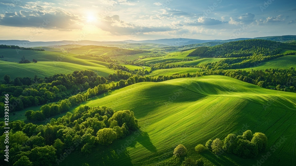 Poster rolling hills adorned with lush greenery stretch across the landscape as the sun sets, casting a war