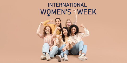 Beautiful young women with clenched fists sitting on beige background. Women history month