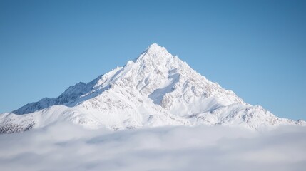 Obraz premium Snowy mountain peak above clouds, winter landscape