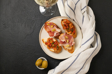 Tasty bruschetta served with wine on gray background. High quality photo
