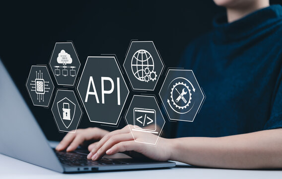 API Application Programming Interface Concept. A person types on laptop, with digital icons representing API development, security, and cloud computing technology. networking application software tool
