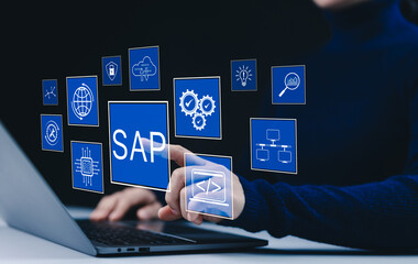 Software concept. SAP software system and enterprise integration. Businesswoman interacts with digital SAP interface on laptop, icons related to cloud computing, analytics, security, and data systems.