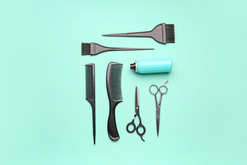 Hairdresser's brushes with scissors and spray bottle on mint background