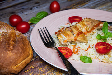 Chicken meat with rice on a plate.