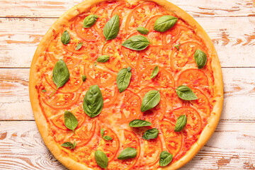 Tasty pizza margarita on light wooden background