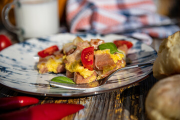 Omelette with egg and ham on a wooden table