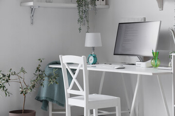 Programmer's desk with computer monitor in light office