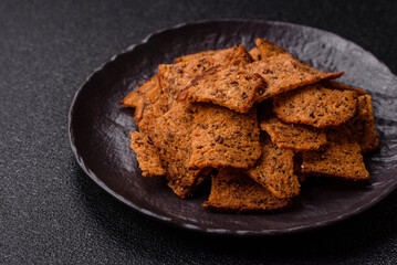 Crispy homemade brown bread chips with seeds and grains