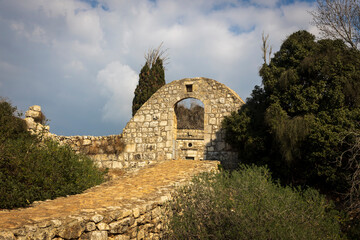 Ancient fortifications on Mount Tabor. Moat bridge and abandoned stone ruins.