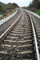 Obraz premium Cinematic View of a Train Track Stretching Towards the Horizon, Blurring into the Hazy Distance, Vertical
