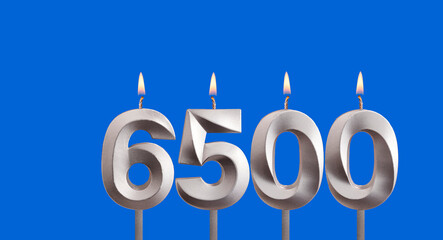 Number of followers or views - Candles form the number 6500.