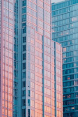 Fototapeta premium Colorful high-rise building facade with geometric patterns. Vintage color tone style, urban cityscape, modern architecture, and contemporary skyline background.