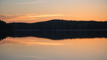 Lake scenery around sunset on a late spring evening in conifer forests of Finland