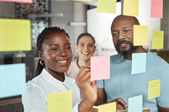 Office, teamwork and business people with sticky note for planning, brainstorming session and writers. Glass, collaboration and employees in creative agency for publication ideas, workflow and smile