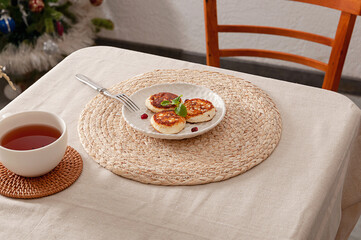 Fragrant fried tvorog pancakes with mint and pomegranate for the perfect breakfast.