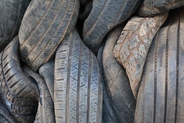 Stack of worn scrap tire for recycling.